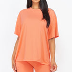 Women's oversized two-piece lounge set featuring a relaxed fit short-sleeve tee and high-waisted biker shorts, available in multiple vibrant colors. Perfect for casual wear, workouts, or athleisure style.