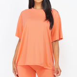 Women's oversized two-piece lounge set featuring a relaxed fit short-sleeve tee and high-waisted biker shorts, available in multiple vibrant colors. Perfect for casual wear, workouts, or athleisure style.