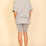 Women's oversized two-piece lounge set featuring a relaxed fit short-sleeve tee and high-waisted biker shorts, available in multiple vibrant colors. Perfect for casual wear, workouts, or athleisure style.