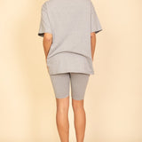 Women's oversized two-piece lounge set featuring a relaxed fit short-sleeve tee and high-waisted biker shorts, available in multiple vibrant colors. Perfect for casual wear, workouts, or athleisure style.