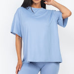 Women's oversized two-piece lounge set featuring a relaxed fit short-sleeve tee and high-waisted biker shorts, available in multiple vibrant colors. Perfect for casual wear, workouts, or athleisure style.