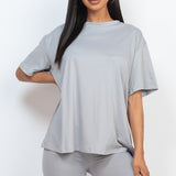 Women's oversized two-piece lounge set featuring a relaxed fit short-sleeve tee and high-waisted biker shorts, available in multiple vibrant colors. Perfect for casual wear, workouts, or athleisure style.