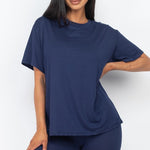 Women's oversized two-piece lounge set featuring a relaxed fit short-sleeve tee and high-waisted biker shorts, available in multiple vibrant colors. Perfect for casual wear, workouts, or athleisure style.
