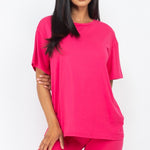 Women's oversized two-piece lounge set featuring a relaxed fit short-sleeve tee and high-waisted biker shorts, available in multiple vibrant colors. Perfect for casual wear, workouts, or athleisure style.