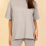 Women's oversized two-piece lounge set featuring a relaxed fit short-sleeve tee and high-waisted biker shorts, available in multiple vibrant colors. Perfect for casual wear, workouts, or athleisure style.
