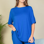 Women's oversized two-piece lounge set featuring a relaxed fit short-sleeve tee and high-waisted biker shorts, available in multiple vibrant colors. Perfect for casual wear, workouts, or athleisure style.