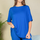 Women's oversized two-piece lounge set featuring a relaxed fit short-sleeve tee and high-waisted biker shorts, available in multiple vibrant colors. Perfect for casual wear, workouts, or athleisure style.
