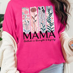 Pink T-shirt with pastel pink and teal floral panel design and bold ‘MAMA’ graphic reading ‘Clothed in Strength & Dignity.
