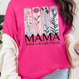 Pink T-shirt with pastel pink and teal floral panel design and bold ‘MAMA’ graphic reading ‘Clothed in Strength & Dignity.