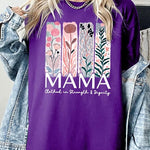 Purple T-shirt with pastel pink and teal floral panel design and bold ‘MAMA’ graphic reading ‘Clothed in Strength & Dignity.