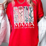 Red T-shirt with pastel pink and teal floral panel design and bold ‘MAMA’ graphic reading ‘Clothed in Strength & Dignity.