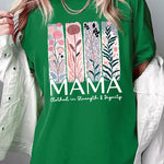 T-shirt with pastel pink and teal floral panel design and bold ‘MAMA’ graphic reading ‘Clothed in Strength & Dignity.