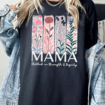 Black T-shirt with pastel pink and teal floral panel design and bold ‘MAMA’ graphic reading ‘Clothed in Strength & Dignity.