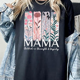 Black T-shirt with pastel pink and teal floral panel design and bold ‘MAMA’ graphic reading ‘Clothed in Strength & Dignity.