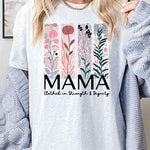 T-shirt with pastel pink and teal floral panel design and bold ‘MAMA’ graphic reading ‘Clothed in Strength & Dignity.
