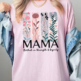 Pink T-shirt with pastel pink and teal floral panel design and bold ‘MAMA’ graphic reading ‘Clothed in Strength & Dignity.