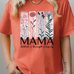 T-shirt with pastel pink and teal floral panel design and bold ‘MAMA’ graphic reading ‘Clothed in Strength & Dignity.