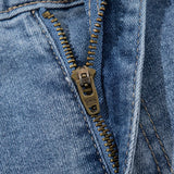 Women's high-waisted denim shorts with faux pearl embellishments and frayed hem – trendy summer jean shorts for casual and chic outfits. Showing the detail.