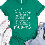 Mint Green graphic T-shirt reading ‘She is strong, loving, warm, fearless, patient, selfless—mom’ styled flat-lay with tan fedora, denim shorts, and greenery.