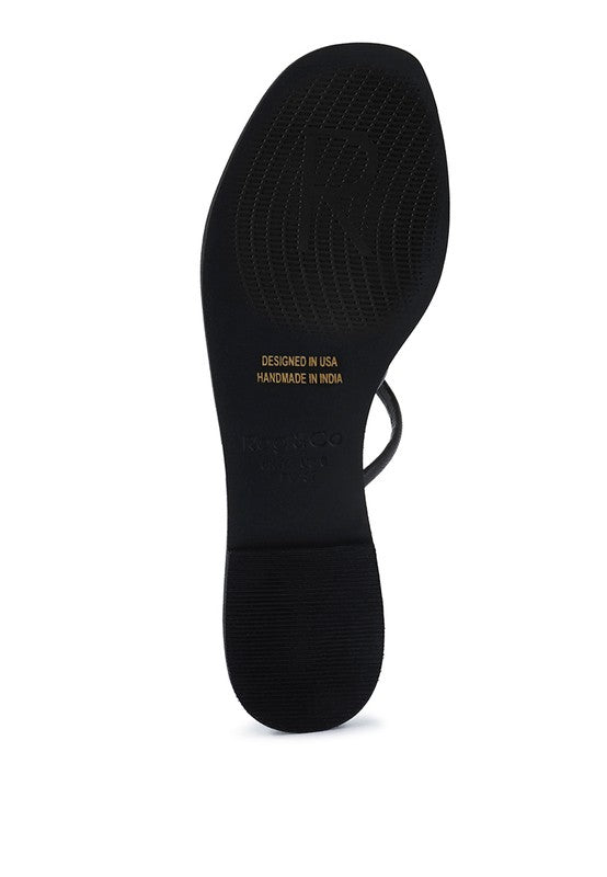 Women's handcrafted black crisscross flat sandals with minimalist strappy design by Rag & Co – stylish slip-on summer footwear.