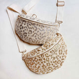 Gold or Silver and ivory woven leopard-print crossbody belt bag with adjustable ivory strap and zip closure, laid flat on a white background.